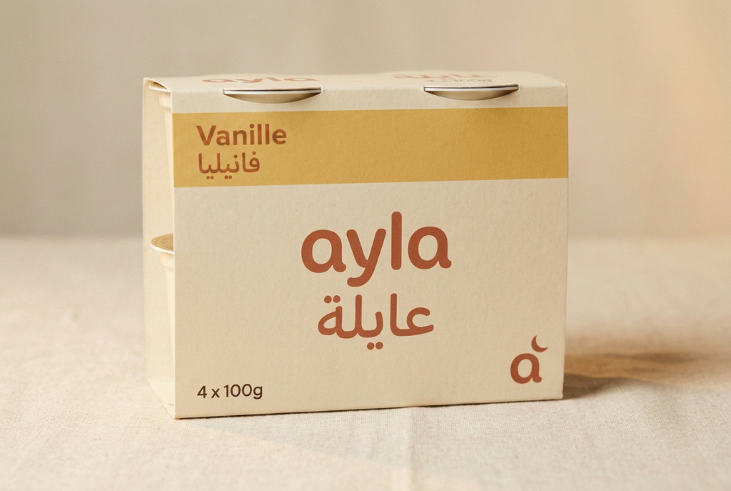 Ayla vanilla dessert pack, four 100g pots, on linen with the bilingual ayla wordmark